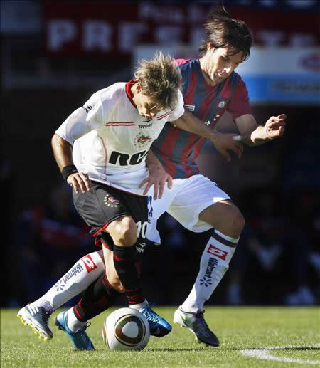 El jugador de Estudiantes de La Plata, Gastón Fernández (i), lucha el balón con Guillermo Pereyra, de San Lorenzo de Almagro (d). Foto: EFE