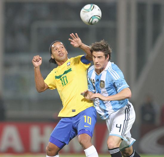 El jugador de Argentina Iván Alexis Pillud (d) disputa el balón con Ronaldinho. Foto: EFE