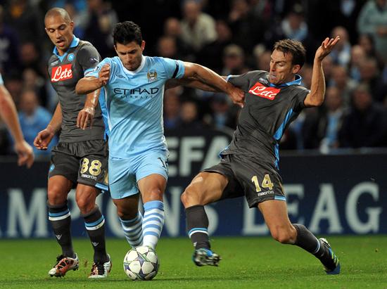 El delantero argentino del Manchester City, Sergio "Kun" Agüero, lucha por el balón con Hugo Campagnaro (i) y Gokhan Inler (d) del SSC Nápoles. Foto: EFE