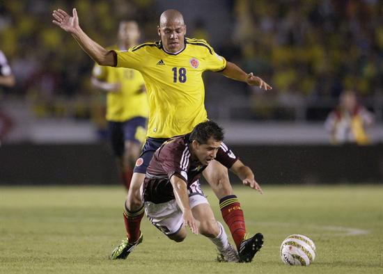 El jugador de la selección colombiana de fútbol Gustavo Bolívar (atrás) disputa un balón con César González (frente) de Venezuela. Foto: EFE