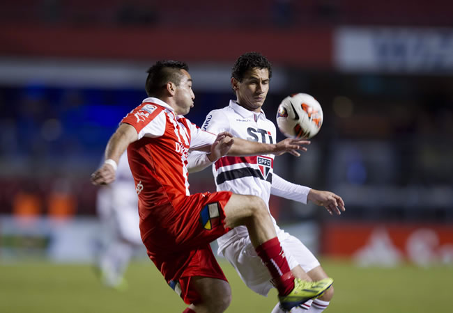 El jugador Ganso (d) de Sao Paulo disputa el balón con Fernando Meneses (i) de Universidad Católica. Foto: EFE